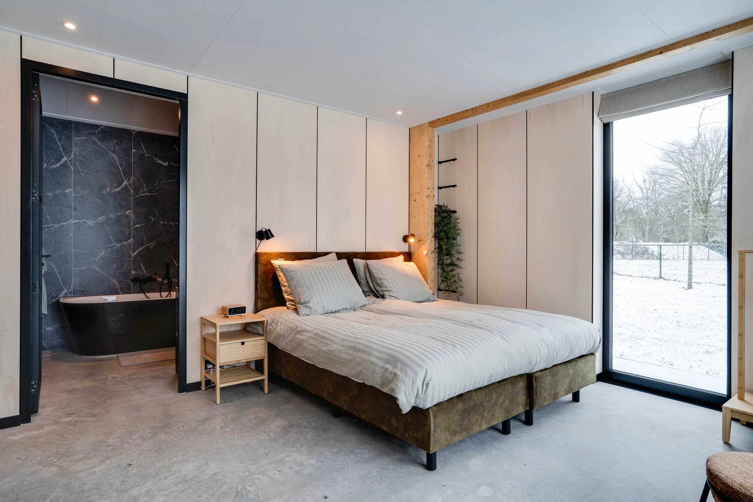 Bedroom with private bathroom and forest view